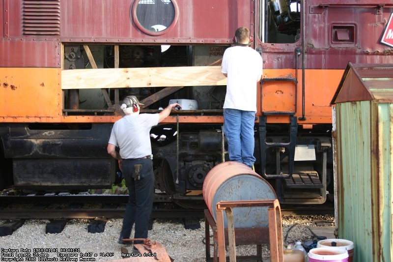 Bob S and Dan M work on replacing a body panal