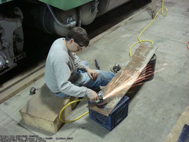 Dan S working on electrical cabinet door 