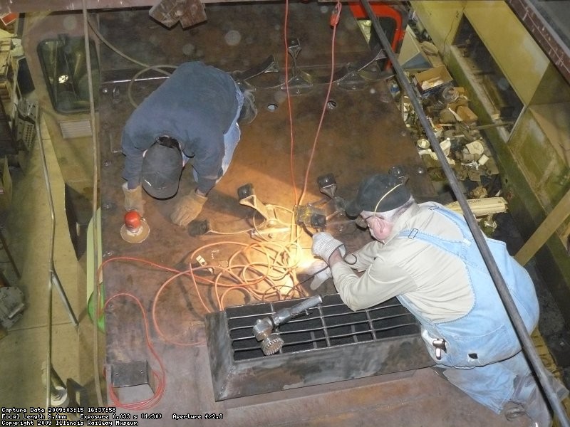 Kyle DA sanding and Roger wire wheeling the roof where the air tanks will go.