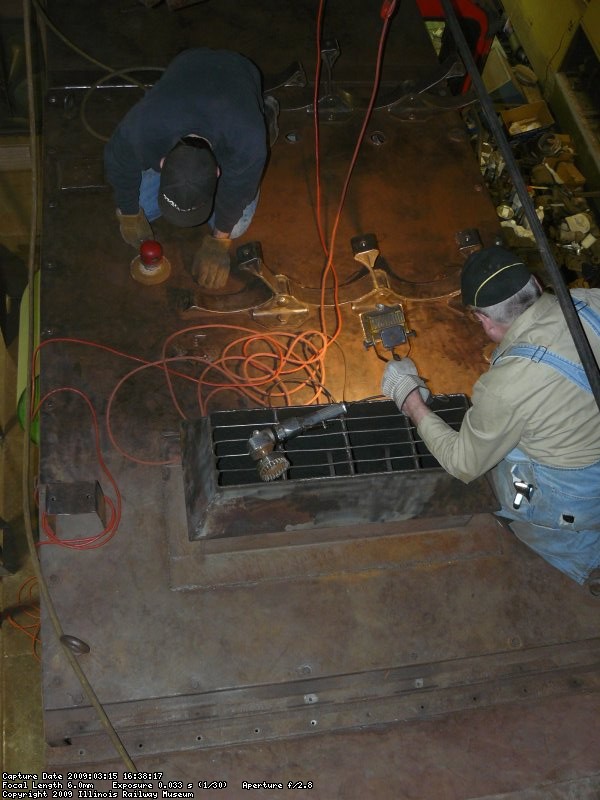 Kyle DA sanding and Roger wire wheeling the roof where the air tanks will go.