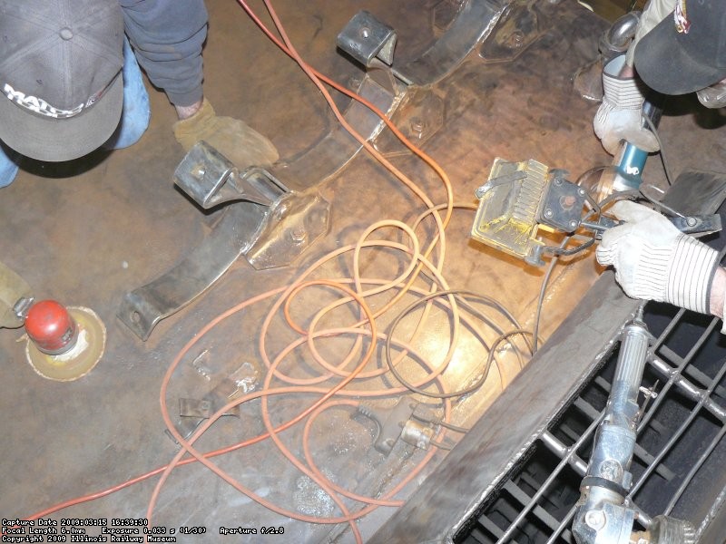 Kyle DA sanding and Roger wire wheeling the roof where the air tanks will go.