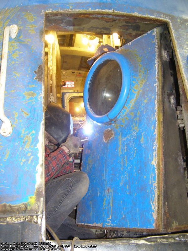 Jamie Kolanowski works on welding in the new nose door hardware