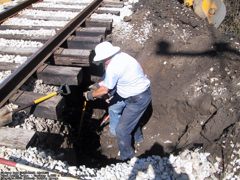 After moving a lot of material with the backhoe, Dave and Jerry taking a turn at digging around the concrete culvert by hand to locate the breach.