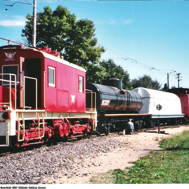 07.10.04 - THE CAR IS BWEING LETTERED BY BOB KUTELLA.  IT SITS IN A TRAIN OF CARS RESTORED THIS YEAR BY THE FREIGHT CAR DEPARTMENT.