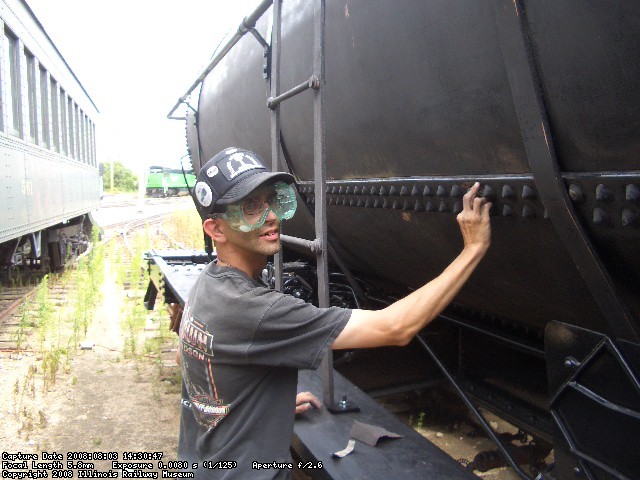 08.03.08 - JOHN BALETTO IS SANDING THE RIVETS SO THAT THE CAR CAN BE RESPRAYED.  HE COMPLETED THE ENTIRE DOUBLE ROW ON THE LEFT SIDE OF THE CAR AND MOST OF THE LADDER.