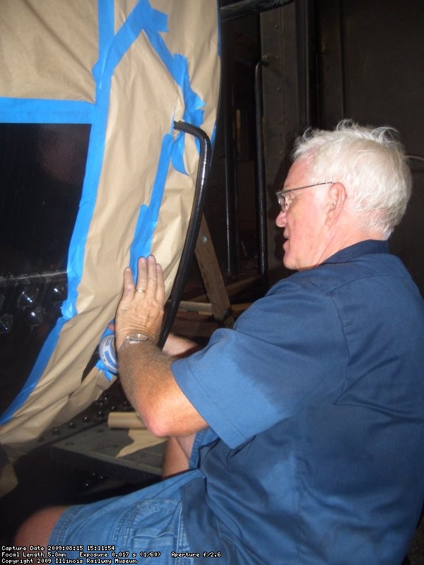 08.15.09 - VICTOR HUMPHREYS AND KIRK WARNER COMPLETED SANDING THE AREAS THAT ARE TO BE PAINTED NEXT WEDNESDAY.  HERE, KIRK WARNER APPLIES TAPE AND PAPER TO PROTECT THE AREAS THAT WILL NOT BE PAINTED FROM OVERSPRAY.