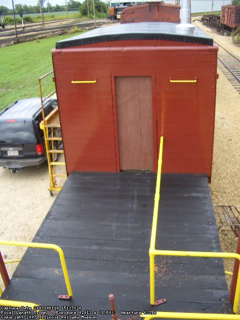 08.18.07 - SEVENTEEN OF THE TWENTY DECK BOARDS ON THE A END ARE NOW BOLTED ONTO THE CAR.  FINISH PAINT HAS BEEN APPLIED TO THE A END OF THE CABOOSE.  ONCE AGAIN RAIN STOPPED THE COMPLETION OF DECK BOARD APPLICATION.