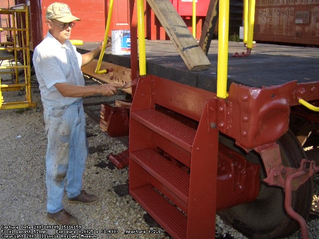 09.09.07 - VICTOR HUMPHREYS APPLIES THE FINAL COAT OF PAINT TO THE COMPLETED AR STEPS.  INTERESTINGLY, WE HAVE PHOTO SHOWING THAT THE AR, BR AND BL STEPS WERE PAINTED MINERAL RED, WHILE THE AL STEPS WERE PAINTED YELLOW.  THE CAR WILL BE RETORED IN THAT MANNER.