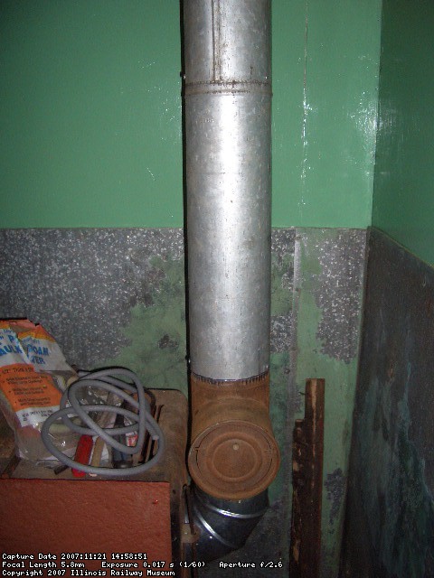 11.21.07 - KIRK WARNER HAS APPLIED THE CHIMNEY VENT STACK TO THE STOVE.