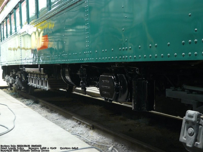 A rebuilt air compressor, now in fresh black paint, shines under the newly painted sides of NSL 749