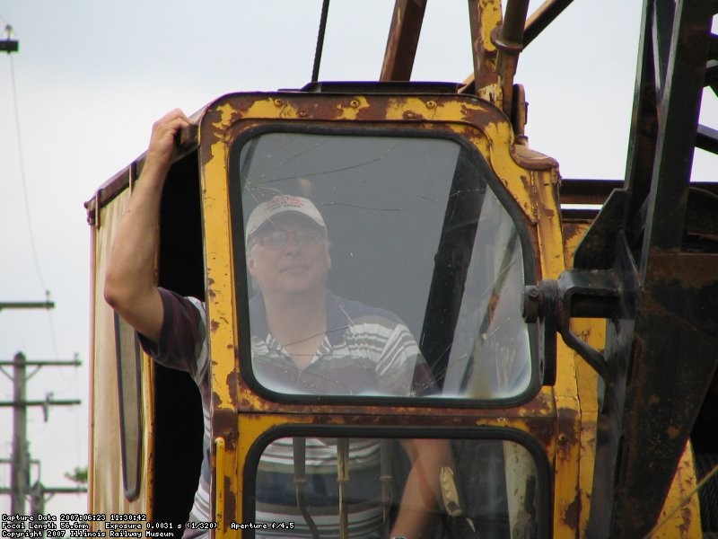 Our resident crane operator watches the load as it is lowered into the pit. (Stuart B. Brosh photo)