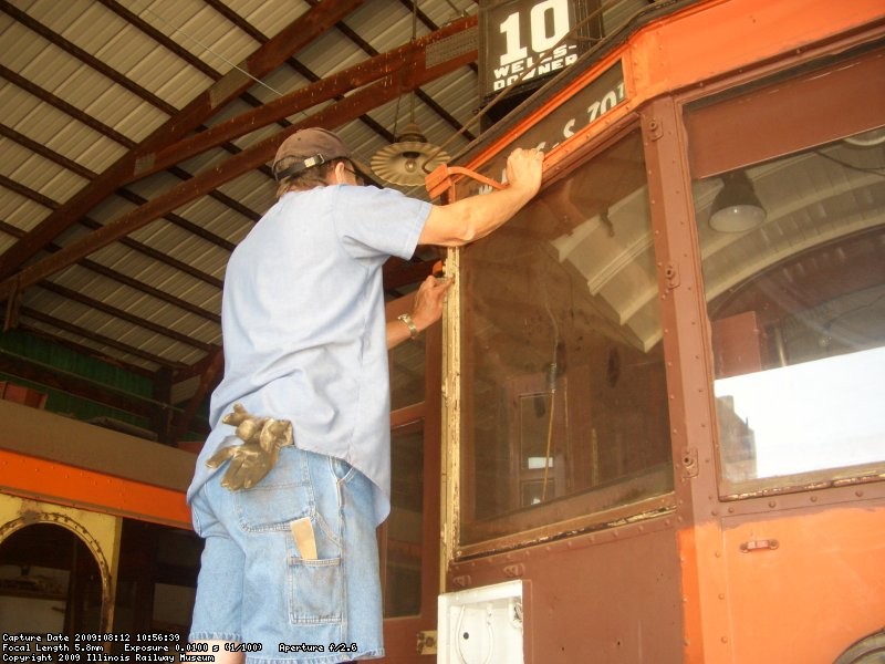 08.12.09 - JOHN FAULHABER IS SANDING THE LETTERBOARD AREA OF THE EAST END OF THE 972 IN PREPARATION FOR PAINTING.