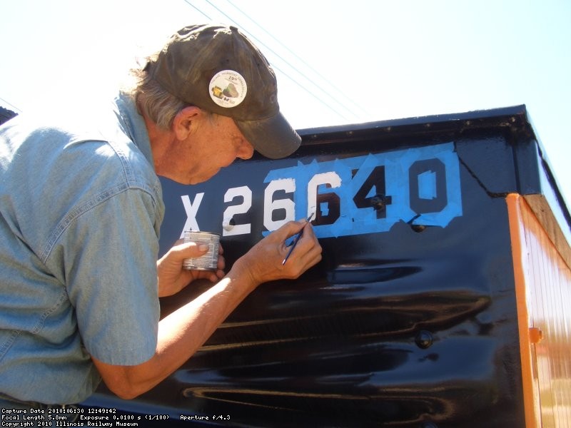 06.30.10 - BOB KUTELLA IS PAINTING ON THE CAR NUMBER ON THE "A" END OF THE CAR.