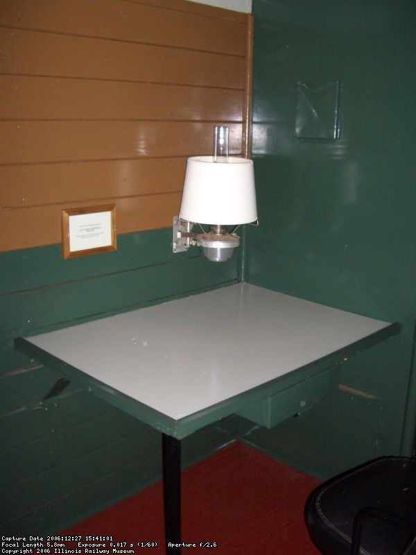 12.27.06 - THE CONDUCTOR'S WORK STATION, WITH KEROSENE LAMP AFTER RESTORATION.  AT THE TIME OF RESTORATION COMMENCEMENT, THE WALLS AND CEILING WERE COVERED WITH SOOT FROM THE KEROSENE LAMP.