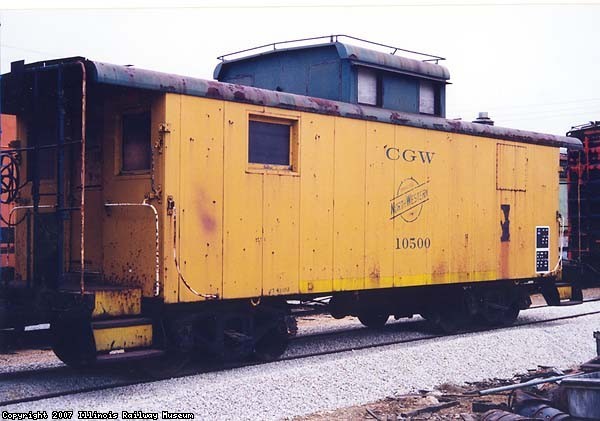1.17.00 - THIS IS THE CAR SHORTLY AFTER RESTORATION COMMENCED.  THIS PHOTO WAS TAKEN BY PETER SCHMIDT IN 2000.  NOTE THAT THE END CUPOLA WINDOWS HAVE HAD STEEL PLATES WELDED INTO THE WINDOW FRAMES.  THE CAR CARRIES CGW AS ITS REPORTING MARK AND 10500 AS ITS NUMBER, WHICH WAS ASSIGNED BY THE CNW.