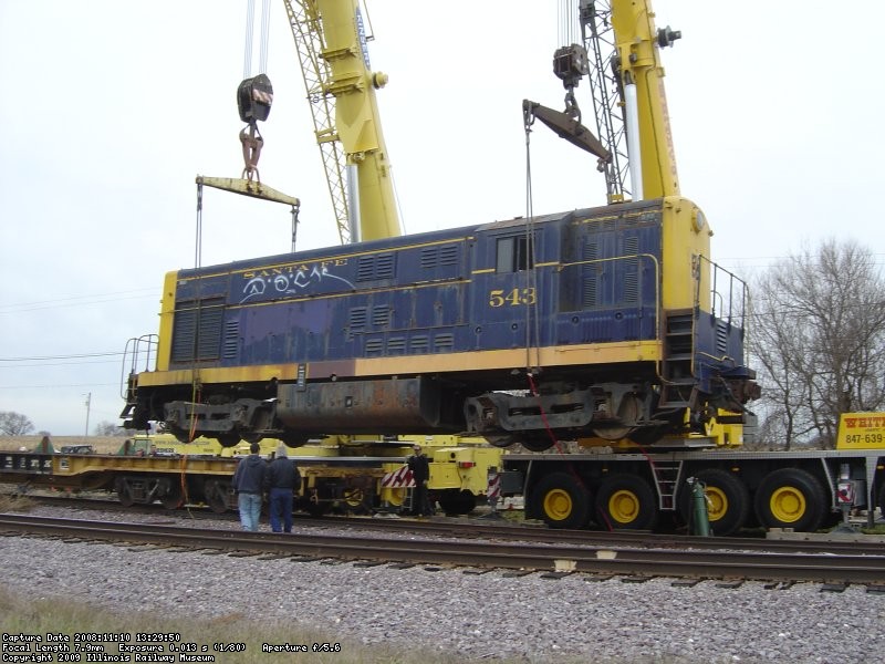 The flat car the 543 spent a year or better on is slowly pulled out from under the engine. 