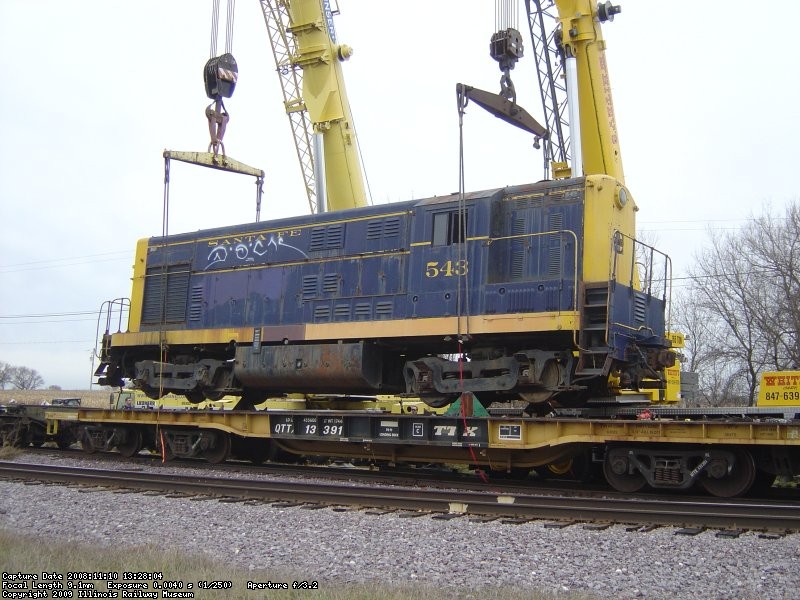The 543 is lifted off the flat car, now it can be slowly pulled out out from under the engine. These cranes made easy work of this. 