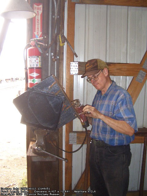 08.13.08 - VICTOR HUMPHREYS IS GRINDING OF THE SECUREMENT BOLTS ON THE PLACARD HOLDR.