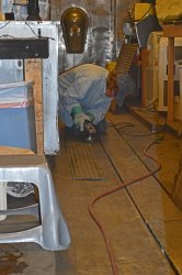 Shelly Vanderschaegen wire wheeling the last piece of the flooring to place