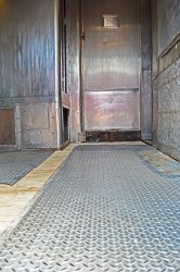 The metal floor was reinstalled - note that there is a cabinet missing as it probably had been removed when the ice cream parlor had installed the door.