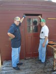 05.30.07 - JOHN FAULHABER AND VICTOR HUMPHREYS HOLD ONE OF THE NEW DOORS TO CHECK THE FIT OF THE DOORFRAME WHICH IS BEING INSTALLED.