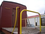 07.04.07 - THE HANDRAIL IN THE FOREGROUN HAS ITS FINAL COAT OF YELLOW AND THE EDGE OF THE ROOF IS IN ITS FINAL BLACK COLOR.
