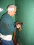 11.28.07 - DICK CUBBAGE IS DRILLING THE FIRST HOLE FOR THE INSTALLATION OF THE DRINKING WATER SUPPLY BRACKET.