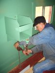 11.28.07 - VICTOR HUMPHREYS IS TIGHTENING THE DRAIN PIPES FOR THE OVERFLOW OF THE DRINKING WATER DISPENSER.