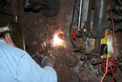 Dennis welds a socket into place