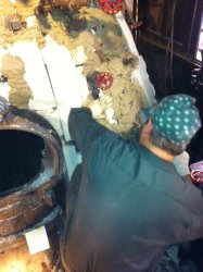 Collin applies insulating mud to the backhead