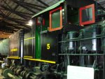 The shay with fresh paint is in the shop for maintenance. The shay with fresh paint is in the shop for maintenance.