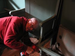 Wayne Baksic works on a seat in the combine car