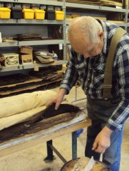 John McKelvey sewing seat bottoms together prior to recovering them