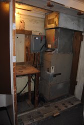 The former cabinet to the left of the furnace