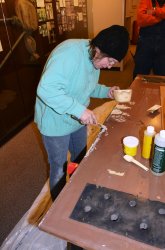 Shelly filling in holes on the vestibule closet door