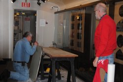 Mike applies epoxy to a Birmingham table while Jon Habegger looks on 2/16/14