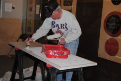 Kevin Kriebs applying tan paint to vestibule door