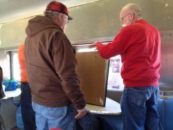 Mark Gellman, Michael Baksic and Jon Habegger look over a display for the Birmingham