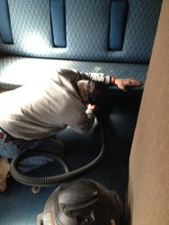 Kevin Kriebs vacuuming in a coach