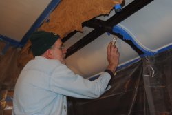 Buzz Morisette painting the lower part of the Ely dining room ceiling