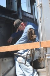 Michael Baksic repairing a vestibule door latch on the RDC - Photo by Shelly Vanderschaegen
