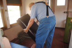 John McKKelvey installing a reupholstered DM&IR 84 smoking section seat bottom - Photo by Shelly Vanderschaegen