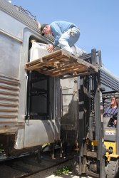 Curator Michael Baksic rode the fork lift up with the AC unit for installation - Photo by Shelly Vanderschaegen