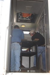 Michael Baksic and Andy Townsend work to position the AC unit  - Photo by Shelly Vanderschaegen