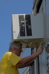 Mark Gellman using his head for AC unit installation - Photo by Jon Habegger 