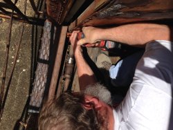 Chuck cutting out old pipe - Photo by Warren Newhauser