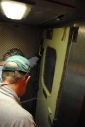 Michael Baksic and Ray Mormann work on the kitchen end door - Photo by Shelly Vanderschaegen