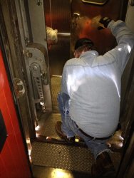 Mark G. and Michael B. kneeling down to work on the kitchen end door - Photo by Michael McCraren