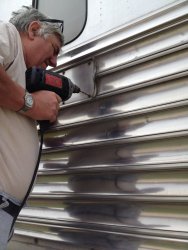 Mark Gellman drilling out the pop rivets and removing the panel - Photo by Michael McCraren