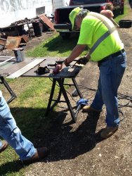 Mark Gellman removes rusted bottom of door - Photo by Michael McCraren